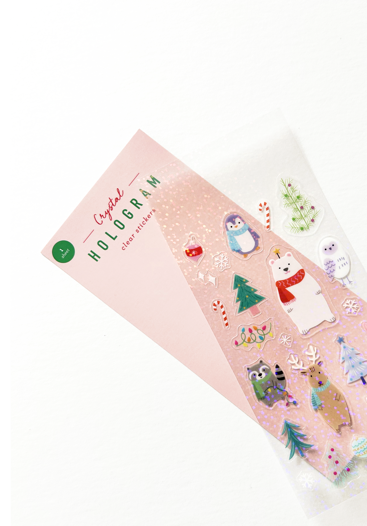 Holographic sticker sheet with holiday animal designs fanned out from packaging card to show texture.