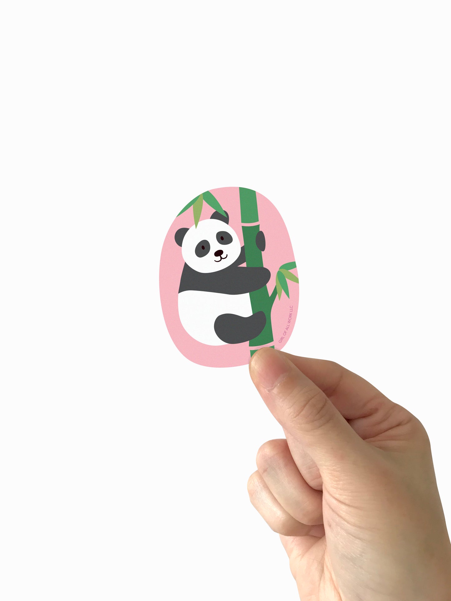 Hand holding a vinyl sticker with a panda design on a white background
