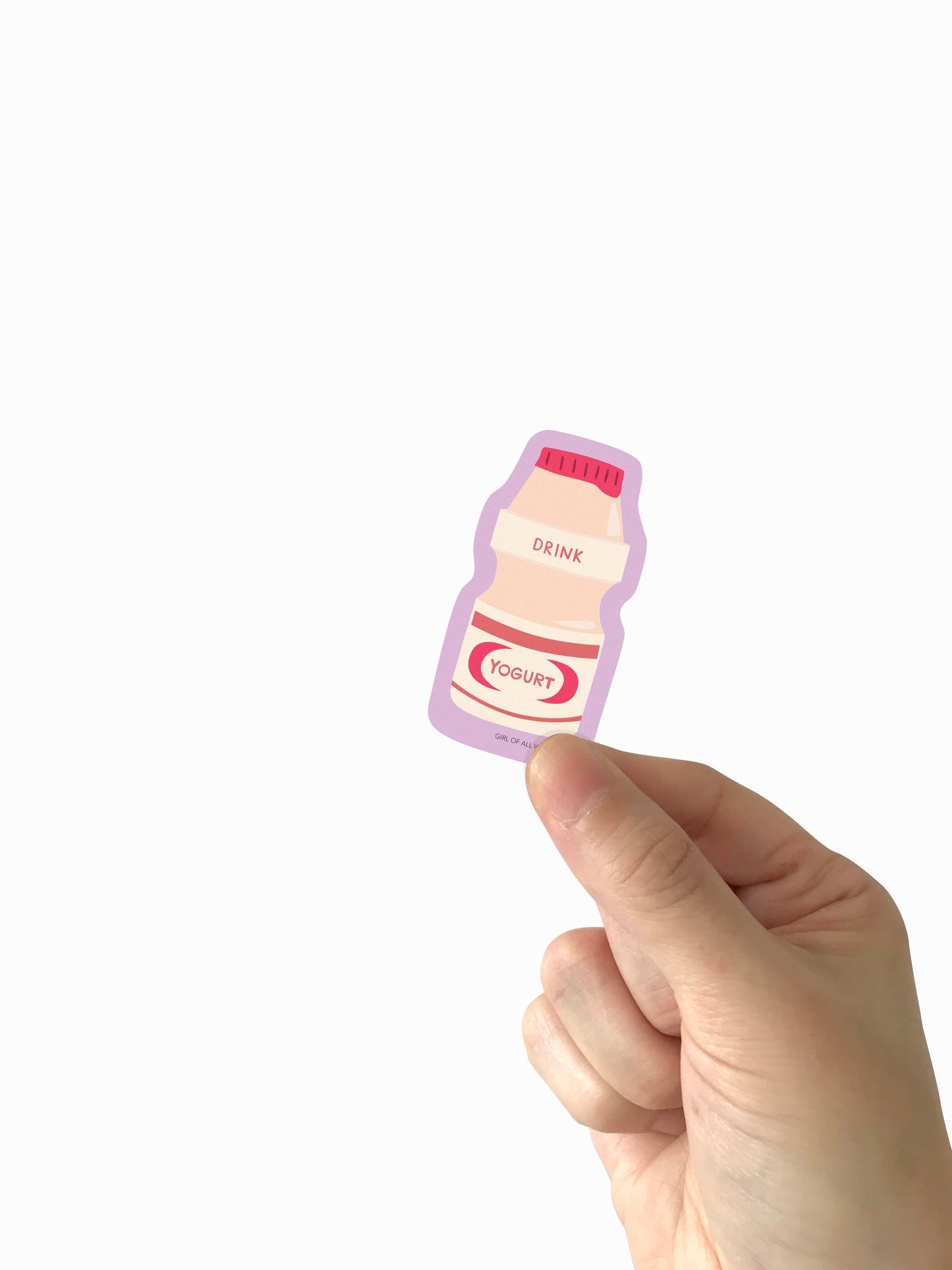 Hand holding a small yogurt drink vinyl sticker on a white background