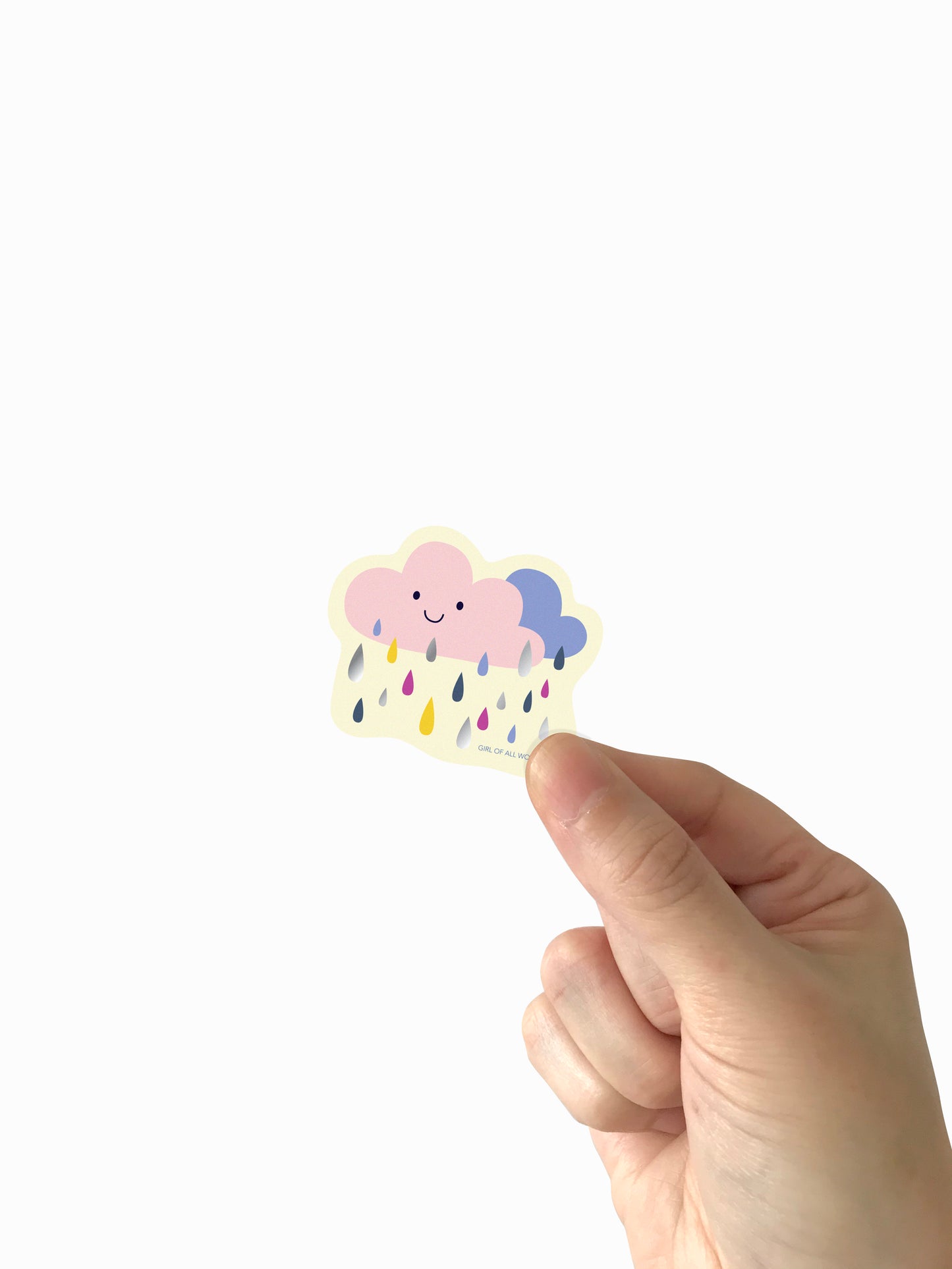 Hand holding a cute cloud-shaped sticker with raindrops on a white background