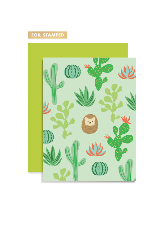 Foil stamped card with cactus and hedgehog design and green envelope on white background