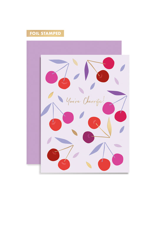 Foil stamped card with cherry design and purple envelope on white background
