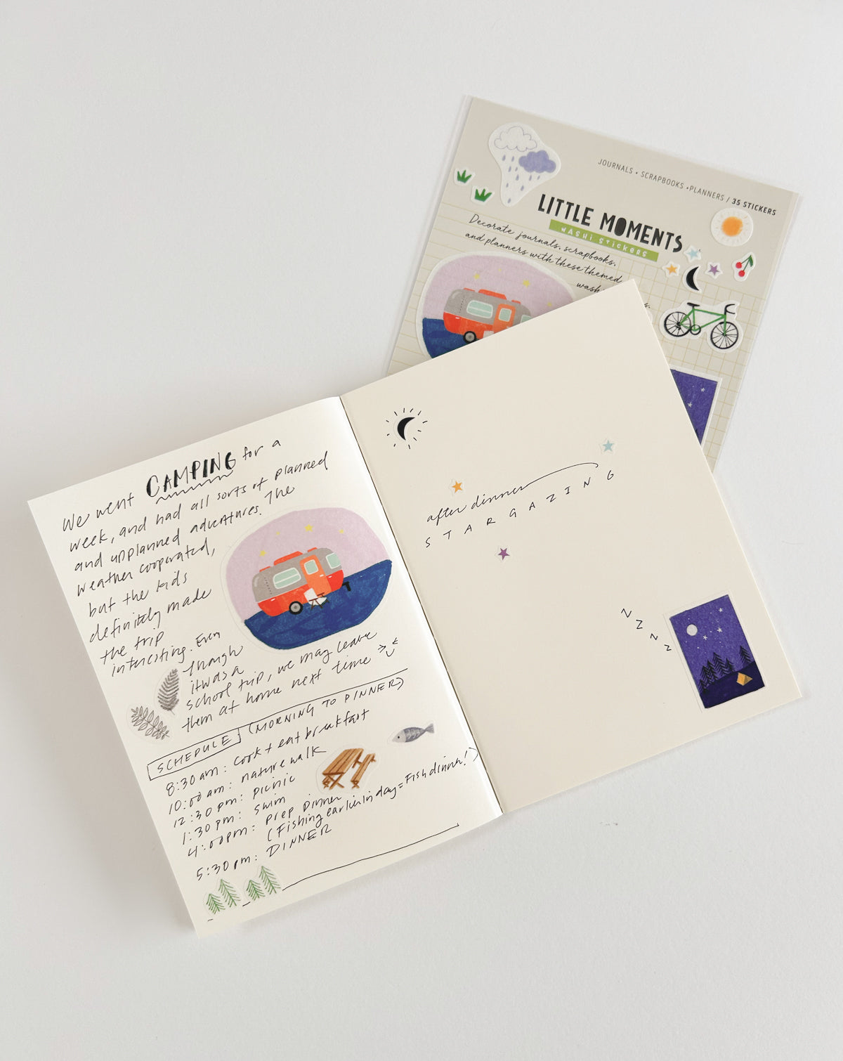 Open journal showing pages decorated with washi stickers. The journal entries document a camping trip, with notes and doodles about the experience. 