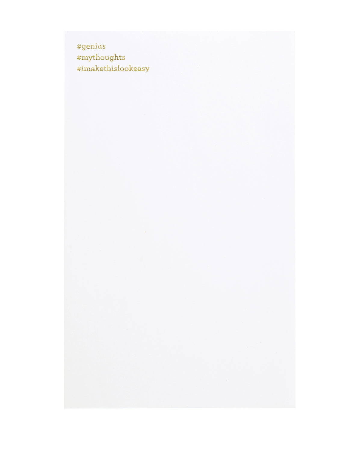 White notepad with gold foil text. "#genius" is printed at the top left, and "#mythoughts" underneath, and "#imakethislookeasy" on the third line. 