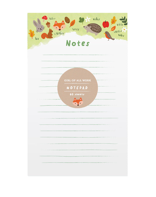Notepad with forest-themed design on a white background