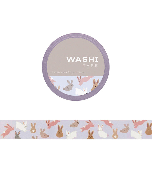 Washi tape with illustrated rabbits hopping among spring flowers and greenery on a pastel background.