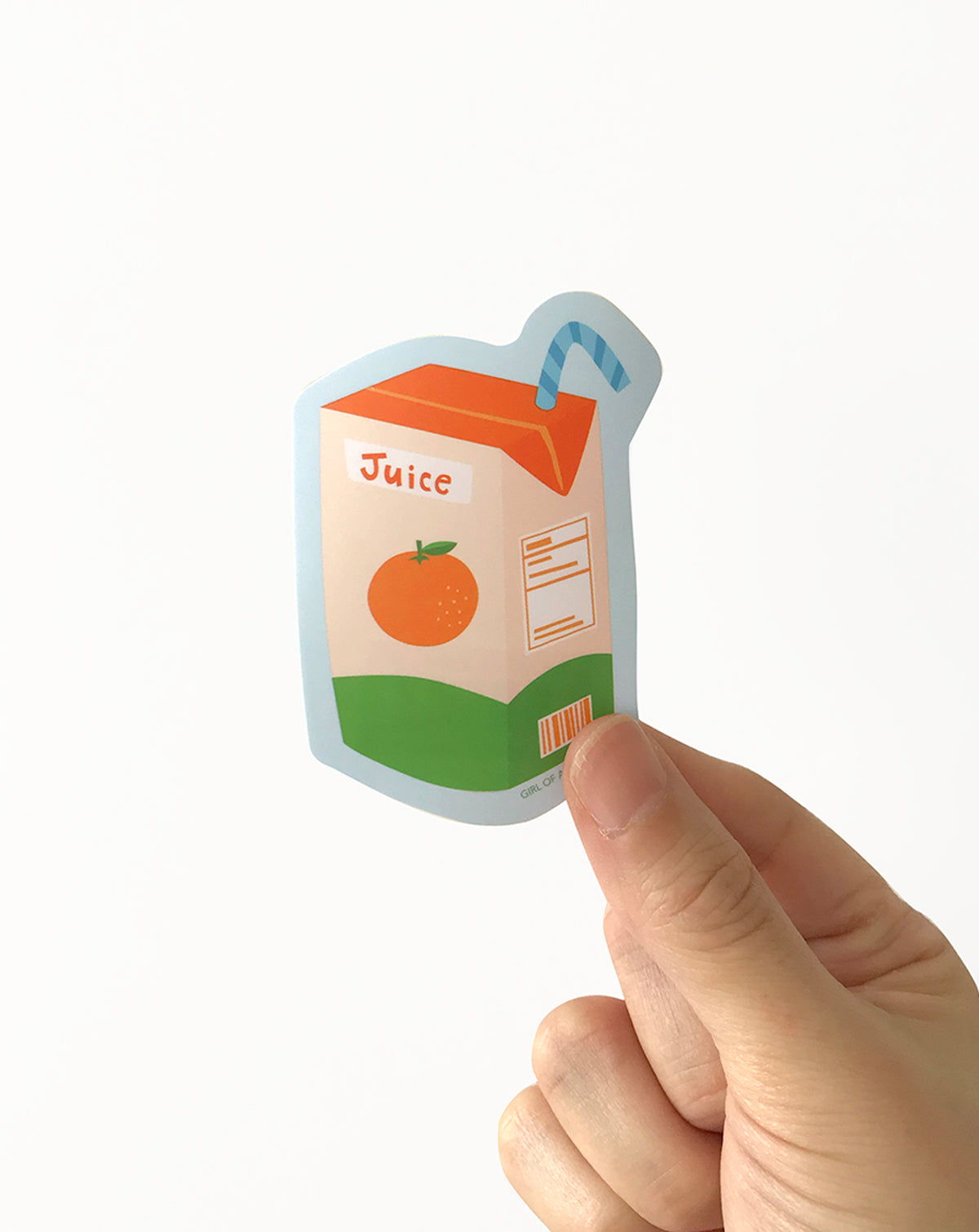 Vinyl sticker of a cute juice box illustration  held by hand on a white background