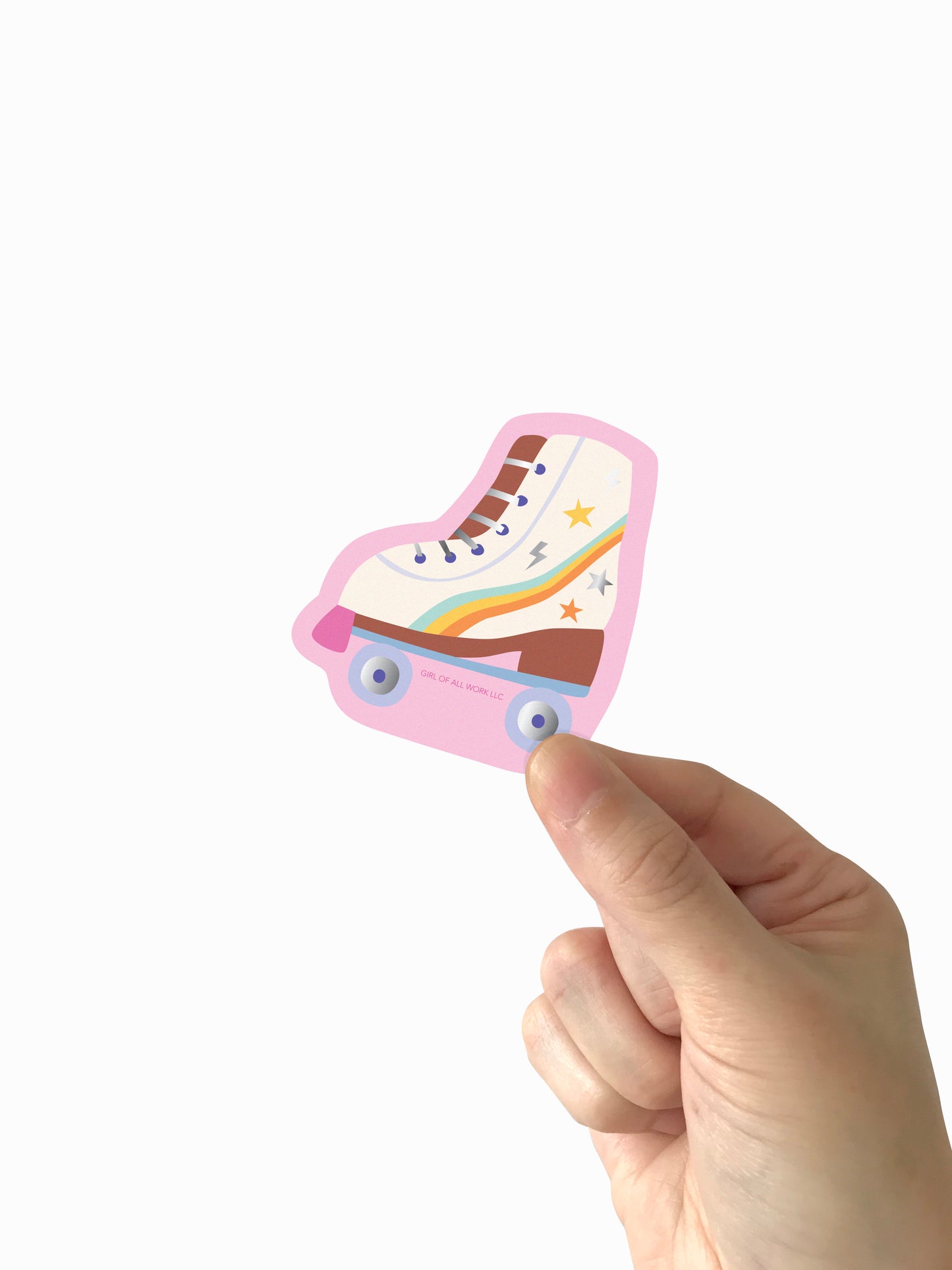 Hand holding a colorful ice skate-shaped vinyl sticker against a white background