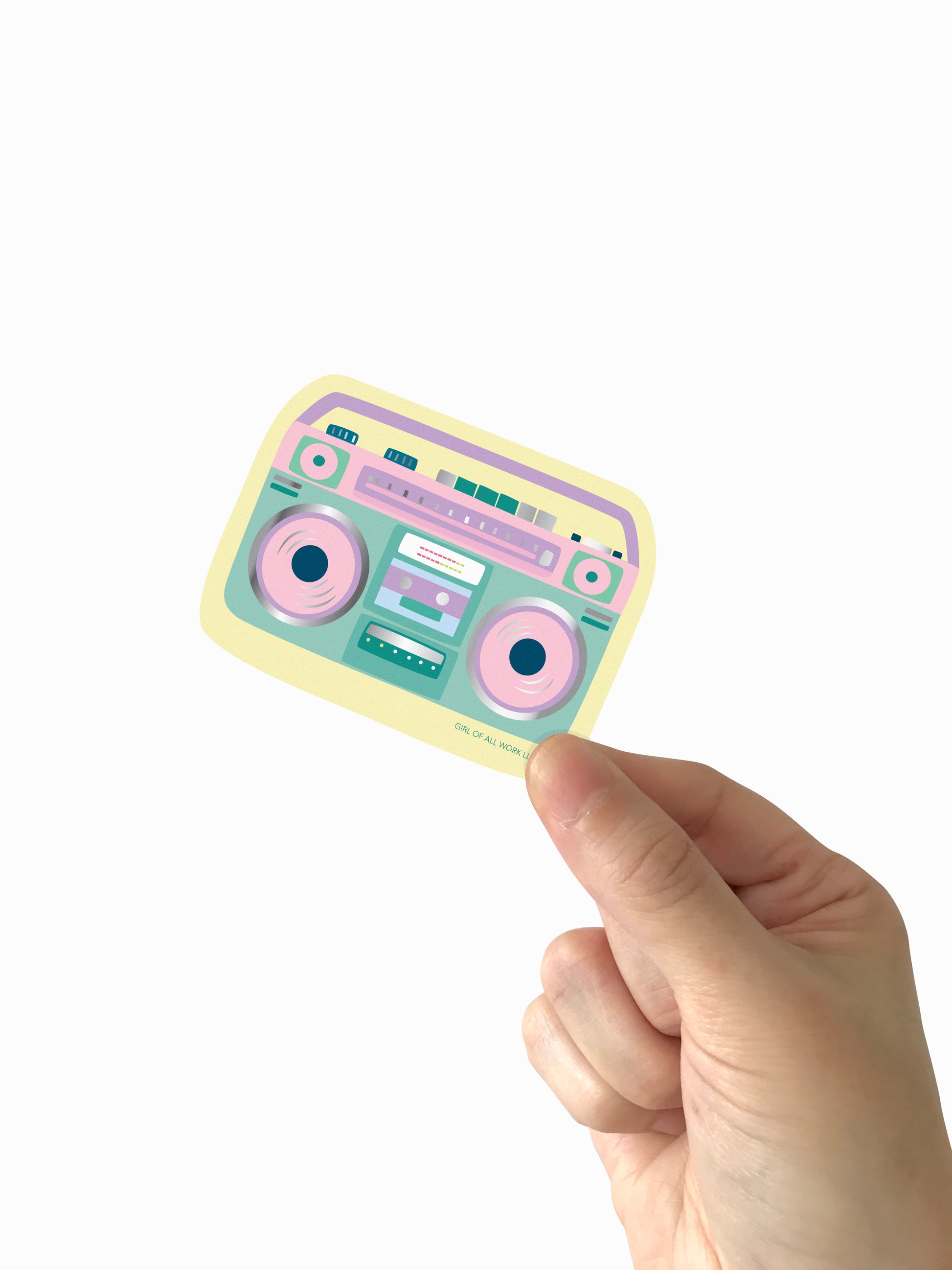 Pastel-colored cassette tape vinyl sticker held by a hand on a white background