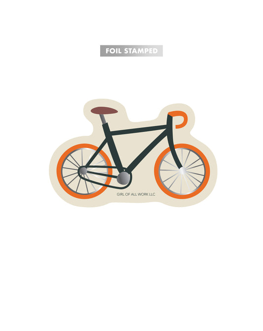 Foil stamped vinyl sticker with bicycle design on a white background labeled with the words "foil stamped."